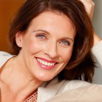 A young brunette woman shows off her healthy smile